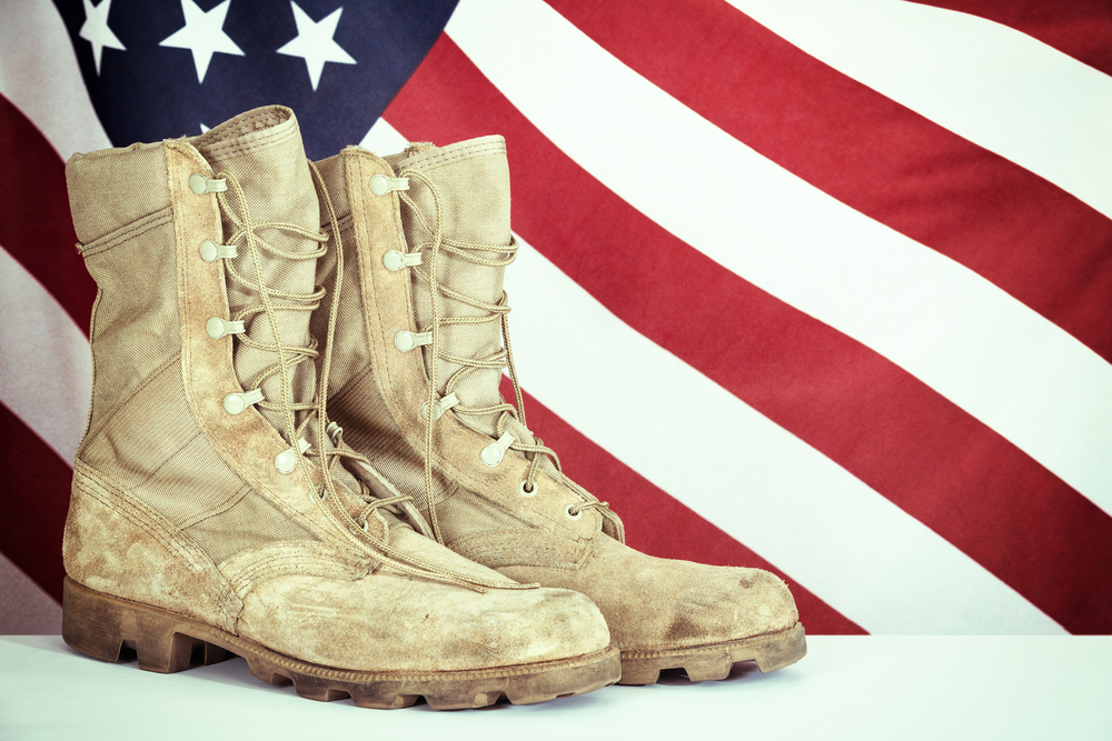 Featured image showing Old combat boots with American flag in the background.