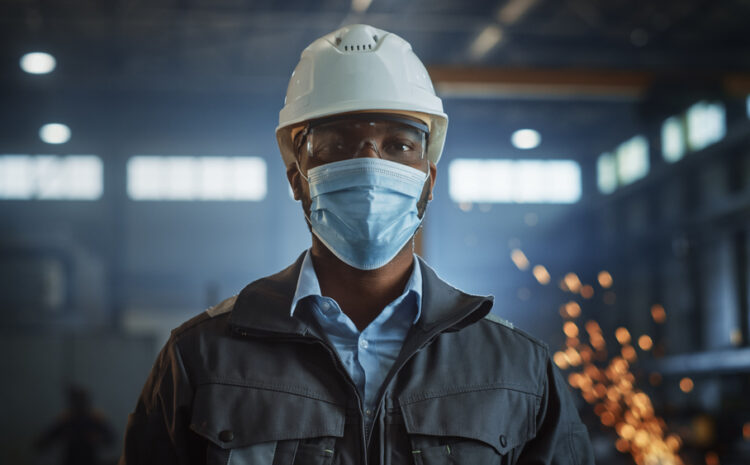 featured image showing Professional Heavy Industry Engineer Worker Wearing Safety Face Mask, Uniform, Glasses and Hard Hat in a Steel Factory
