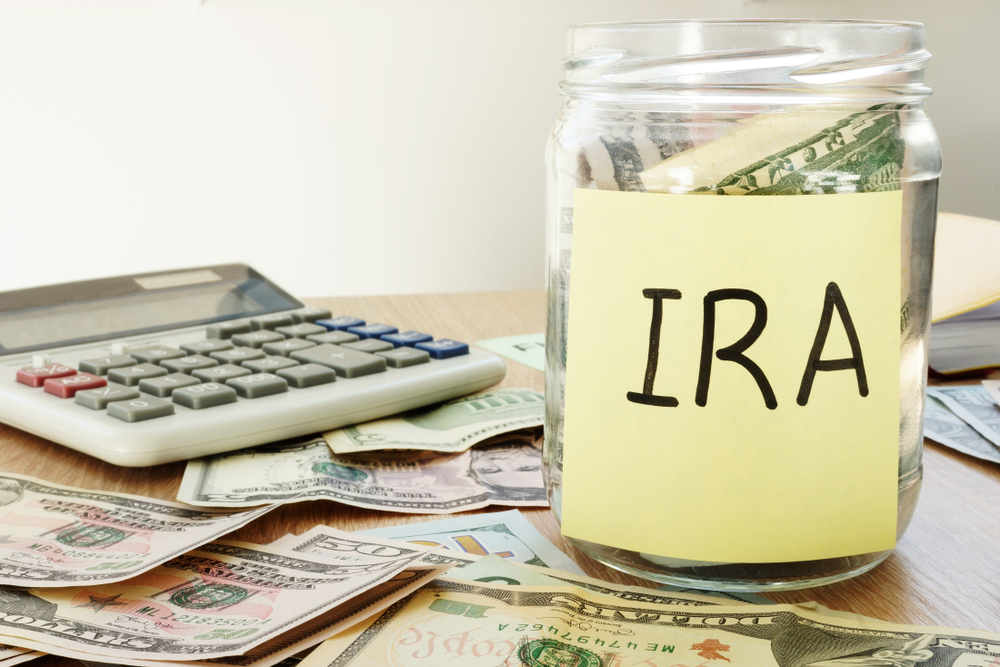 Featured image showing IRA written on a stick and jar with dollars.