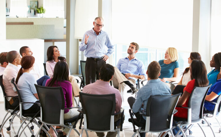 Featured image showing Businessman Addressing Multicultural Office Staff Meeting